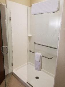 a bathroom with a glass shower with a towel at Comfort Inn & Suites West - Medical Center in Rochester