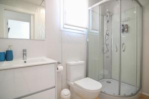 a bathroom with a shower and a toilet and a sink at Villa con piscina privada - Polop in Polop