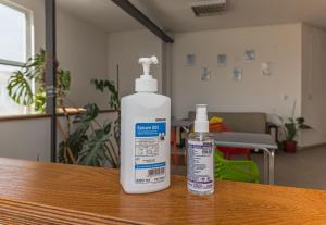 two bottles of cleaner sitting on top of a table at Hostel Ghimbav Airport in Ghimbav