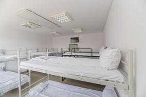 a row of beds in a hospital room at Hostel Ghimbav Airport in Ghimbav
