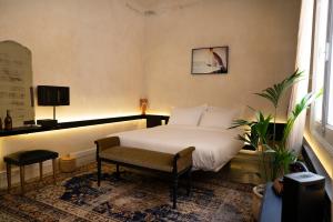 a bedroom with a bed and a chair in it at Shila Athens in Athens