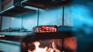 a piece of meat is cooking in an oven at Zenit Convento San Martin in Donostia-San Sebastián