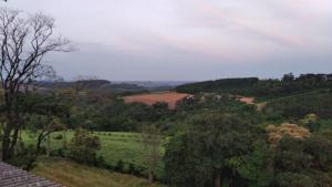 a view of a hill with trees and a field at RUBBO HOTEL in São Valentim