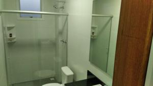 a bathroom with a glass shower and a toilet at RUBBO HOTEL in São Valentim