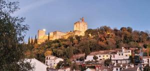 a castle on top of a hill with houses at Casa Mirador Alhambra in Granada