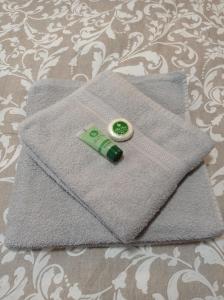 a grey napkin with a green button on it at Central Home in Tríkala