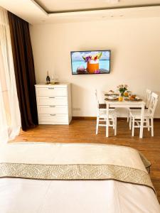 a bedroom with a bed and a dining table at Pirin Golf Studio Apartment in Razlog