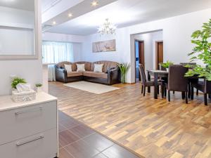 a living room with a couch and a table at MIKRAS LUXURY APARTMENT in Sinaia