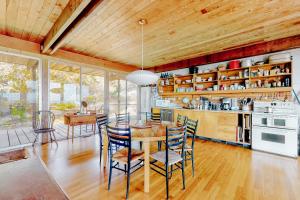 a kitchen and dining room with a table and chairs at The Eliot Noyes in Chilmark