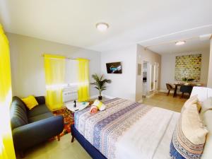 a bedroom with a bed and a couch and a table at Miami International by Lowkl in Miami Beach +54 photos