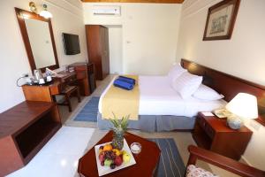 a hotel room with a bed and a table with a tray of fruit at Nuweiba Club Resort in Nuweiba
