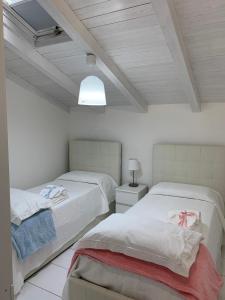 En eller flere senge i et værelse på Villa Bonanno Conti