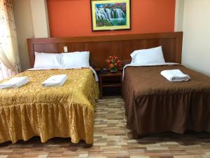 Postel nebo postele na pokoji v ubytování Sumaq Hotel Tacna