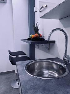 a kitchen counter with a sink and a fruit on a shelf at Jacuzzi Apartment Code 96 in Zagreb
