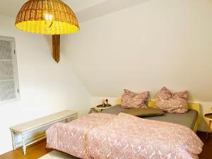 a bedroom with two beds and a lamp at Into The Green Apartment in Markt Nordheim
