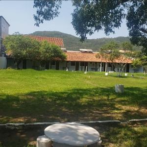 a large yard with a building in the background at Guesthouse da Barra in Florianópolis
