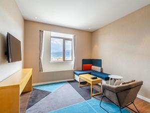 a living room with a couch and a window at Holiday Inn Express Litang by IHG in Lithang