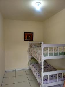 a bedroom with two bunk beds and a picture on the wall at Le Petit Chérie in Blumenau