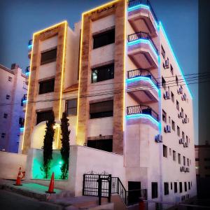 a building with lights on the side of it at شقق مرحبا المفروشة marhaba furnished apartment in Amman