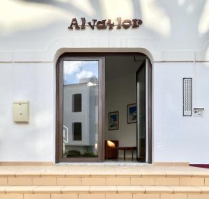 an entrance to a white building with a sliding glass door at Sea Gardens - Alvaflor - Vilamoura in Vilamoura