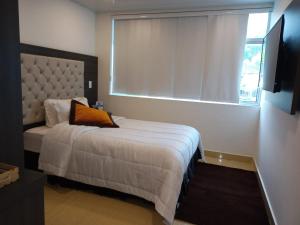Postel nebo postele na pokoji v ubytování Hotel San Antonio Guarne