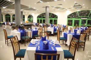 a banquet hall with blue and white tables and chairs at Nuweiba Club Resort in Nuweiba