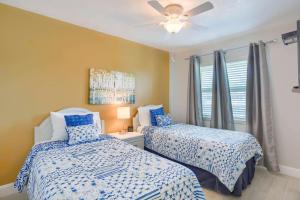 a bedroom with two beds and a ceiling fan at 106 Seagate in Clearwater Beach