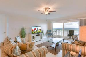 a living room with a couch and a tv at 106 Seagate in Clearwater Beach