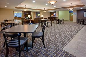 a restaurant with tables and chairs in a room at Holiday Inn Express Devils Lake, an IHG Hotel in Devils Lake