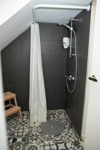 a shower with a shower curtain in a bathroom at Casa do Arco in Amarante