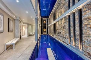 a swimming pool in a building with a brick wall at Best Western Plus Le Lavarin Avignon in Avignon