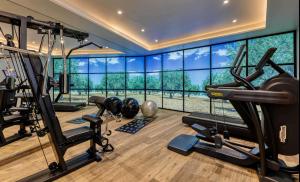 a gym with several tread machines and a large window at Best Western Plus Le Lavarin Avignon in Avignon +122 photos