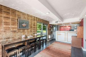 a kitchen with a bar with stools at Econo Lodge Kearney - Liberty in Kearney