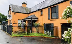 an orange house with a black gate in front of it at The Mews Motel in Launceston