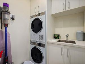 a kitchen with a microwave and a sink at Stonehill Villa - 3 Bed in Queenstown