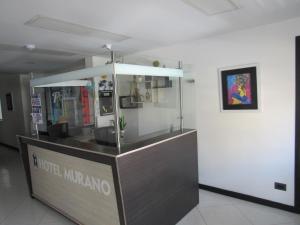 a food counter in a building with a picture on the wall at Hotel Murano Medellín in Medellín