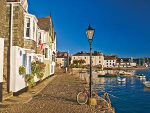 a bike parked next to a street light next to a river at Simples in Dartmouth