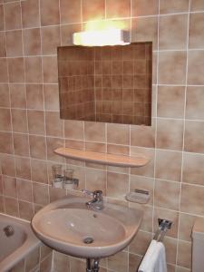 a bathroom with a sink and a mirror at Landgasthof Sonne in Mainhardt