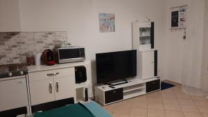 A television and/or entertainment centre at Onix - Orfű Apartman