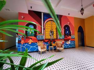 a childrens play room with a mural on the wall at Anchanlina Hotel - SHA Plus in Chalong 