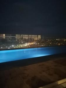 a view of a city at night from a train at Menlyn Maine Luxury Apartments in Pretoria