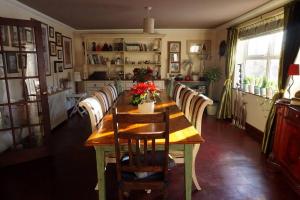 a dining room with a long table and chairs at Innis House in Insch