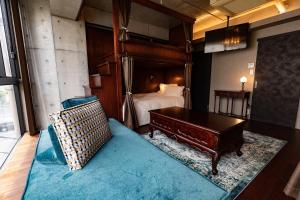 a bedroom with a bed and a piano in it at Creare Ryogoku in Tokyo
