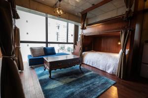 a bedroom with a bed and a large window at Creare Ryogoku in Tokyo