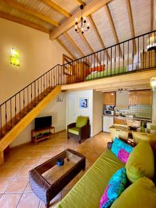 a living room with a couch and a staircase at La Riviera Barbati Seaside Apartments & villas in Barbati