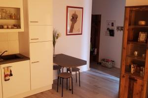 una pequeña cocina con mesa y sillas en una habitación en Ferienwohnung in Birkenwerder mit Balkon, en Birkenwerder