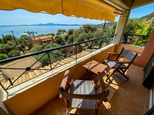 a balcony with chairs and a view of the ocean at La Riviera Barbati Seaside Apartments & villas in Barbati
