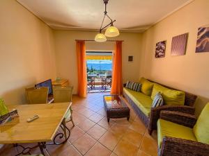 a living room with a couch and a table at La Riviera Barbati Seaside Apartments & villas in Barbati