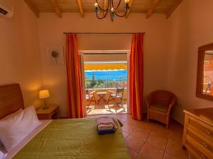 a bedroom with a bed and a view of the ocean at La Riviera Barbati Seaside Apartments & villas in Barbati