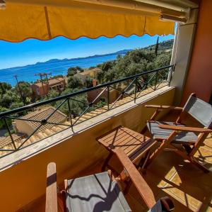 a balcony with chairs and a view of the ocean at La Riviera Barbati Seaside Apartments & villas in Barbati